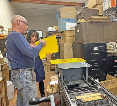 Judy Kuhlman and Tom Lanis work on the printing of the Hardrockers Holiday 50th Anniversary posters Photo credit DeAnne Gallegos