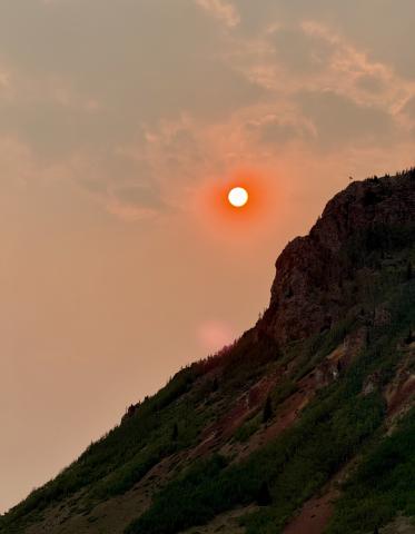 Wildfire smoke from regional fires caused the sun to look like a bright orange orb in the sky photo by DeAnne Gallegos