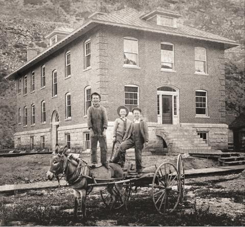 Three boys stand on a light wagon pulled by a burro in front of the Miners Union Hospital, 1315 Snowden Street, probably in 1912. From left are Myron Henry, Bill Gearry and Arthur Dreyer. The hospital building was only five years old at the time. Later this year its exterior will be restored in a $370,000 project funded by the State Historic Fund and the Department of Local Affairs. Photo courtesy of San Juan County Historical Society
