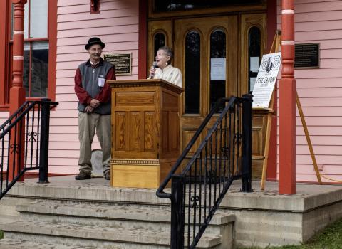 Society Chairman Beverly Rich and long- time board member and Treasurer Scott Fetchenhier dedicate a plaque to the late “ Zeke” Zanoni. Zanoni served on the board for many years and spearheaded the Society’s extensive efforts to preserve the local history of hard- rock mining.