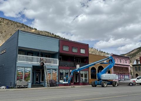 Harley store building on Greene St being painted before summer season