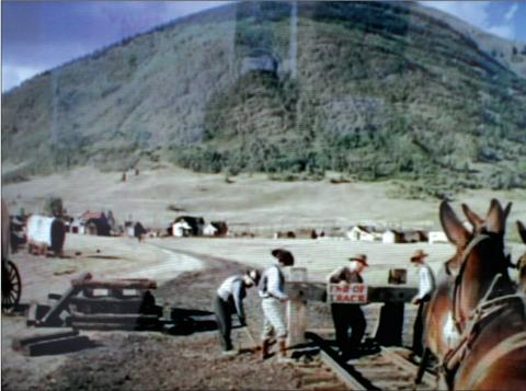 In this image from the movie “A Ticket to Tomahawk” railroad workers remove the “End of Track” sign as a 20-mule team begins to pull the Emma Sweeney locomotive out of Epitaph, Colo., to Tomahawk. The scene was shot in the summer of 1949, where the old Silverton, Gladstone &amp; Northerly Railroad split from the Denver &amp; Rio Grand tracks, near the present intersection of Cement and 12th streets.