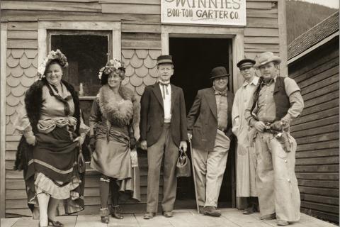 Photo Courtesy of: San Juan County Historical Society Costumed characters on Blair Street involved in promotion of tourist business along the street. Group of six is posed on the porch of the structure at 1154 Blair, owned at the time by the Bairds. Left to right: Sarah (Sally) Waddington, Betsy Baird, Gregory Greene, Ralph O. Baird, “Tulsa Kid” (name not cited), Ray Irwin. Photographer was Herold Waddington. So ... who was the Tulsa Kid?