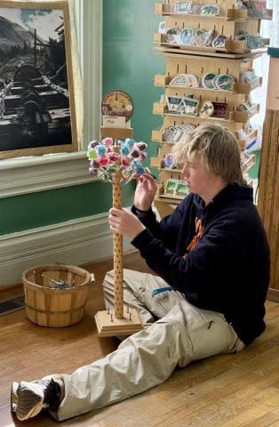 photo by DeAnne Gallegos Phen Mead helps set up the Silverton Visitor Center for opening day on Saturday