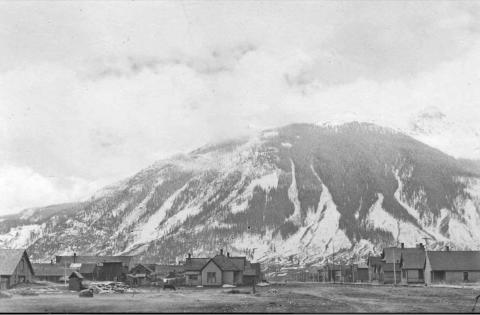 Reese Street with Sultan Mountain in the background, taken from the west edge of what is now Courthouse Square looking southwest down Reese. The rear of the livery stable which once stood on the Courthouse Square can be seen at left. The old brick courthouse can be seen on the right side of Reese Street. This photo is believed to have been taken between 1895 and 1905.