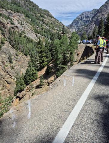 Aug 5th fatal accident photo shows CSP chalk lines of tires going over edge while trying to turn around on highway 550. Photo by CSP