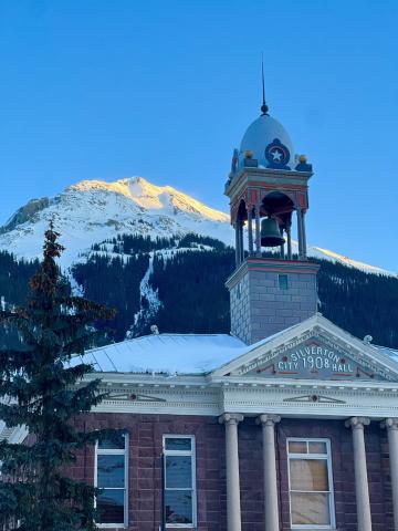 Town Hall at sunset Monday evening had a clear blue sky above it. Below zero frigid temps settled in that night. Photo credit DeAnne Gallegos