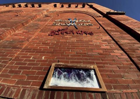 Artist Hillary Cable’s work displayed on the brick of the Power House. Photo by Hillary Cable