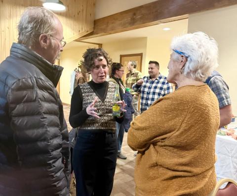 Elizabeth Stuffings chatting with San Juan County Commisioner Scott Fetchenheir &amp; com-munity member Sue Morris at candidate's night last December photo by DeAnne Gallegos