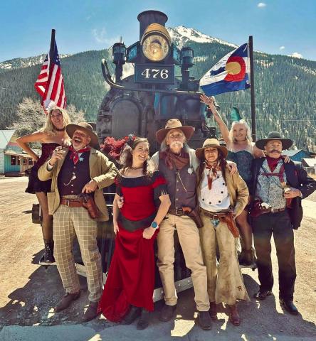 Group of western and Victorian characters pose with steam engine 476. Photo credit Misty French