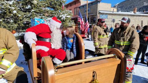 Anyela Carmack looking Santa right in the eye and asking for a puppy. Photo credit Gina Rosato