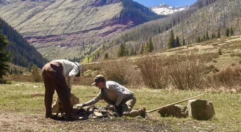 SJMA's Forest Ambassadors Morgan and Kyndall cleaning out a fire ring along South Mineral Road before the crowds arrive for the season. Photo by John Mashburn
