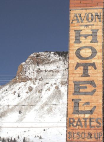 The Avon Hotel at the corner of Blair and 10th streets still advertises great rates, with snow-covered Anvil Mountain in the background. Photo: Mark Esper