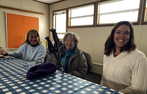 Seniors and volunteers sitting down together Photo provided by Becky Joyce
