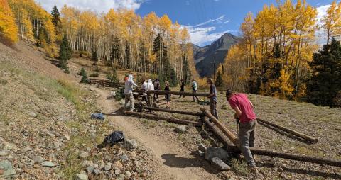 Building a fence amongst the fall colors on the Baker’s Park trail. Photo credit Silverton Singletrack Society