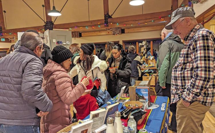 Train Store owner Bob Boeder and shoppers at the annual Mistletoe Market. Photo credit Silverton Creative District