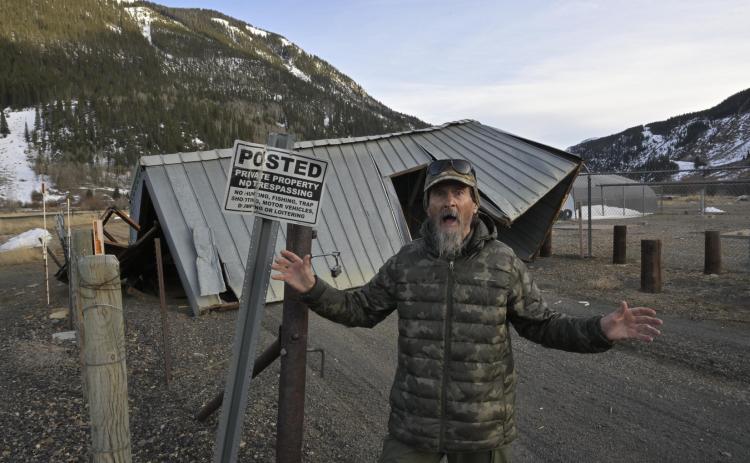 Fred the Weather Man in front of the San Miguel Power coop shed that got tumbled for more than 200 feet early Sunday morning