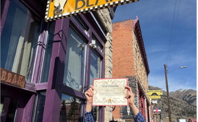 Coffee Bear owner Holly Huebner shows off her YearRounder certificate given to her by SJDA Director Sarah Moore. Photo by SJDA