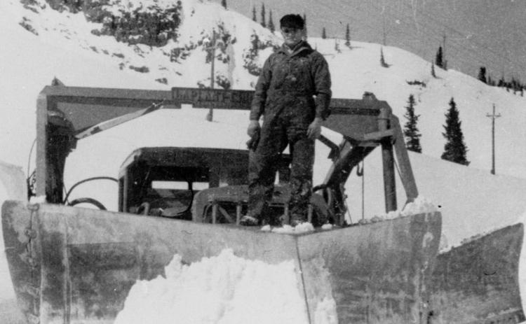 Red Mountain Pass, 1932 A 21-foot A-shaped wedge plow on U.S. 550 on Red Mountain Pass, with Louie Dalla standing on the blade.