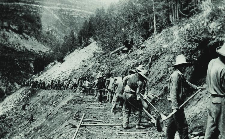 After the new Colorado Highway Department was asked to take over the former Otto Mears toll road from Ouray to Silverton in 1916, portions of the route were rebuilt to locations much higher above the Uncompahgre River to avoid frequent flooding. In 1918, this was how a new portion of the road high above the river was being constructed. It was tough, painstaking work by hand and with explosives. Colorado Department of Transportation Archives, Denver.
