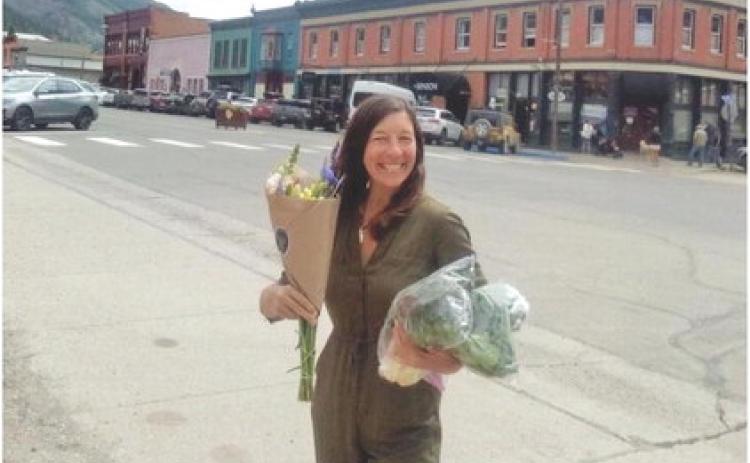 Myste French showing off farmers market goods. Photo by Kharis Weller