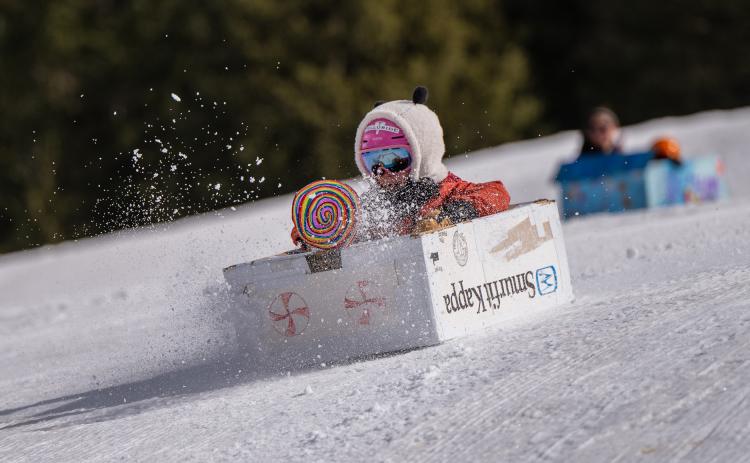 Racer flying down the hill in a box decorated with this year's theme Candy Land. Photo credit Wesley Berg