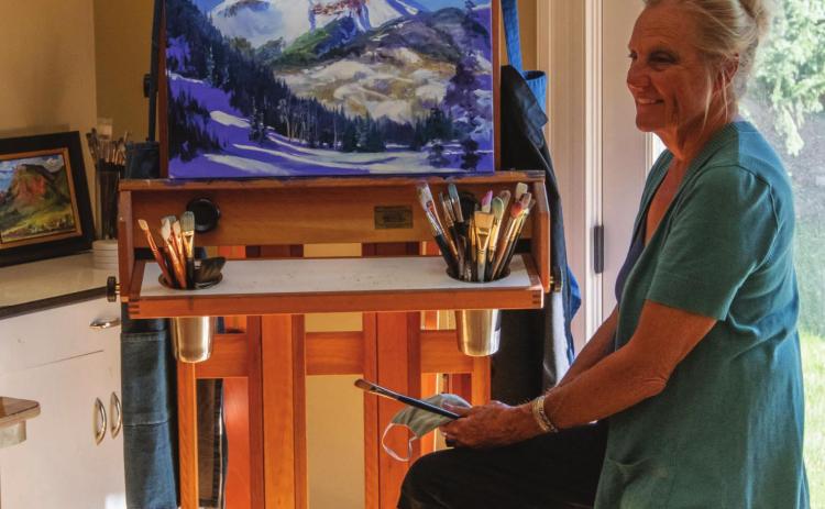 Eileen Fjerstad in her studio with a painting of Engineer Mountain in progress. Photo Credit Wesley Berg