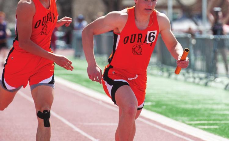 Paton grabbing the baton in the 4x400 relay. The team took first place in the this category. Photo Credit David Emory he team took first place