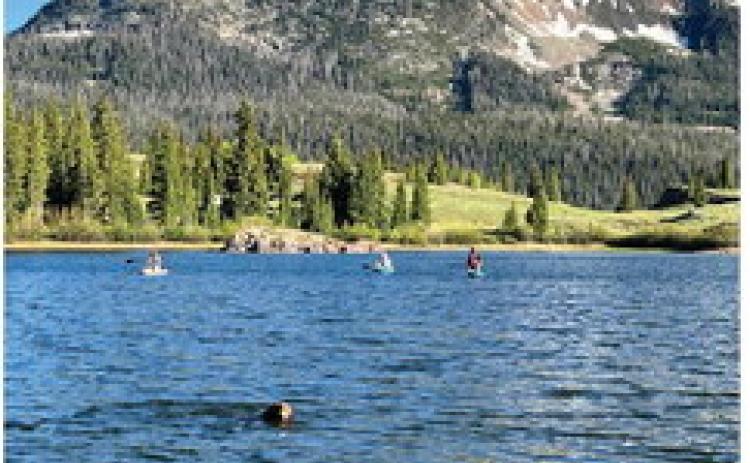 Silverton locals and Ruger Dog take an evening paddle board session after work up at Molas Lake. Photo credit DeAnne Gallegos