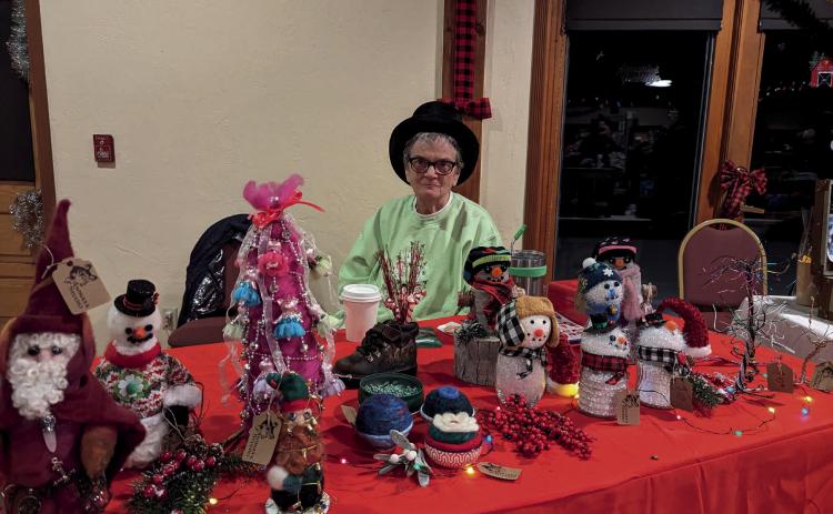 Photo credit Silverton Creative District Deborah Runion looking festive at her table for the Mistletoe Market.