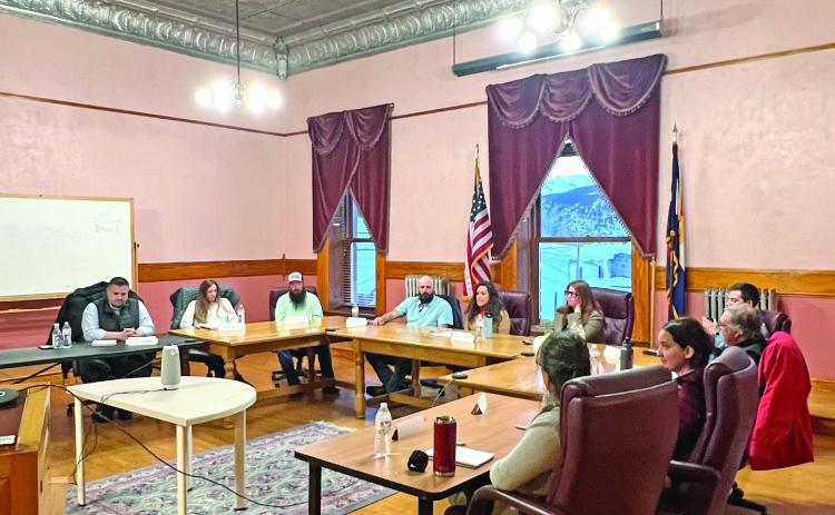 The candidates seated at the horseshoe table to answer questions. Photo credit DeAnne Gallegos
