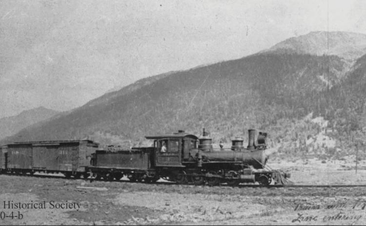 A Silverton Northern Railroad train hauls 10 carloads of zinc concentrates into Silverton, around 1925, pulled by SN #4, with two men on the third boxcar. San Juan County Historical Society photo