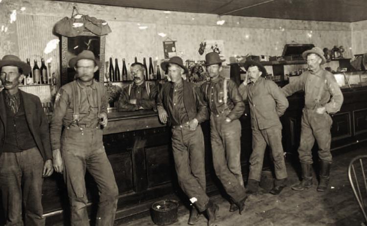 An unidentified saloon in the 1890s, with a long bar and relatively low ceiling, probably in the early 1890s. A poster on the wall mentions the Silverton Railroad. The saloon could have been in Silverton or Red Mountain Town. Photo courtesy of San Juan County Historical Society