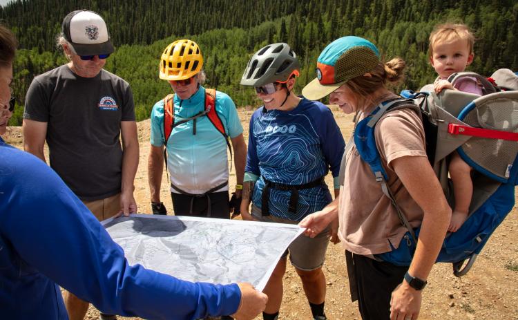Group of local mountain bikers look at map of future Bakers Park Trails . Photo by Cracked Compass Photography