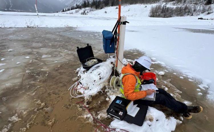 Collecting groundwater samples from a monitoring well on the Mayflower Mill Tailings Impoundment #4