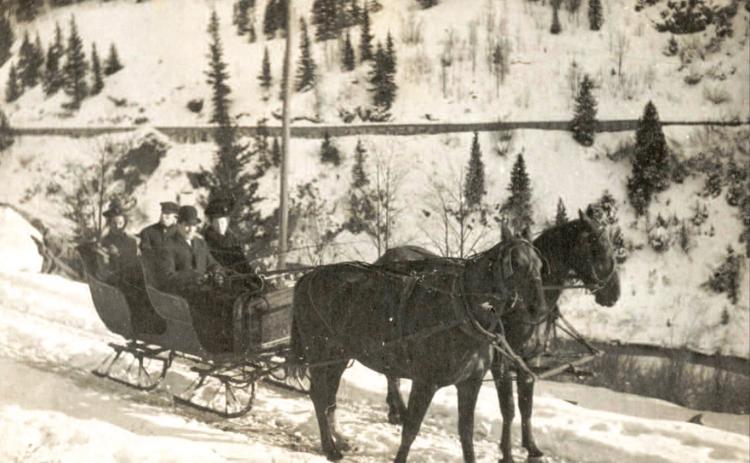 Enjoying a sleigh ride behind a two-horse team on Christmas Day, 1906, were, from left, Alice Dyson, James Dyson, Dan McNaughton and Edith Dyson McNaughton (she and Dan were married Oct. 19, 1906). The photo was probably taken on the Howardsville road above Arastra Gulch, based on the flume in the background. Photo Courtesy of the Edith Dyson McNaughton Archive