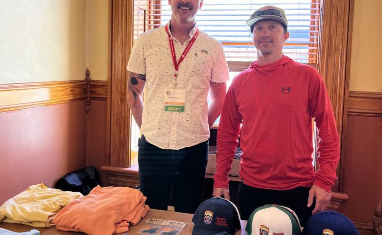 SMR volunteers Brenden Goetz and Billy Grimes man the swag table at the MMS. Photo credit DeAnne Gallegos