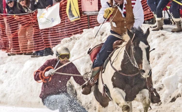 Skier and cowboy racing down Blair Street. Photo from Silverton Skijoring Facebook Page