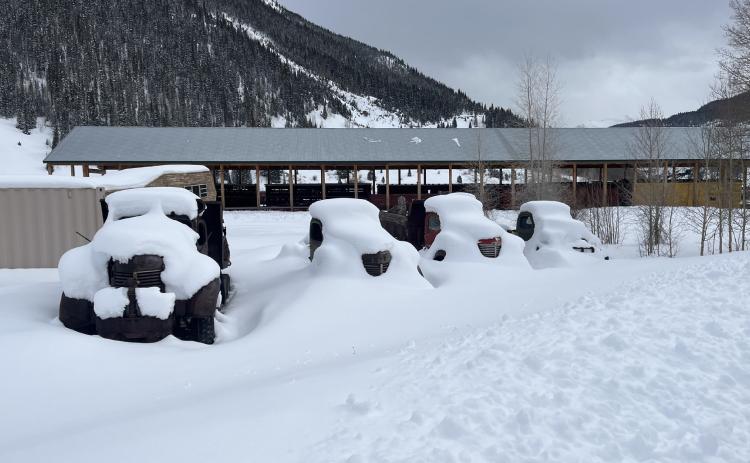 Photo credit Scott Fetchenhier Snow on the antique trucks near the train depot.