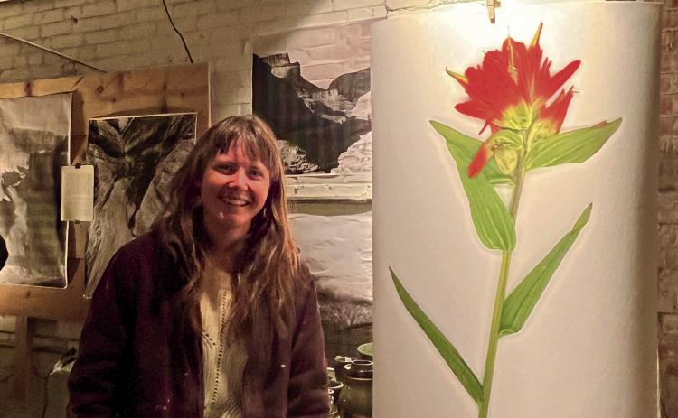 Hannah Green standing next to her artwork. Photo by DeAnne Gallegos
