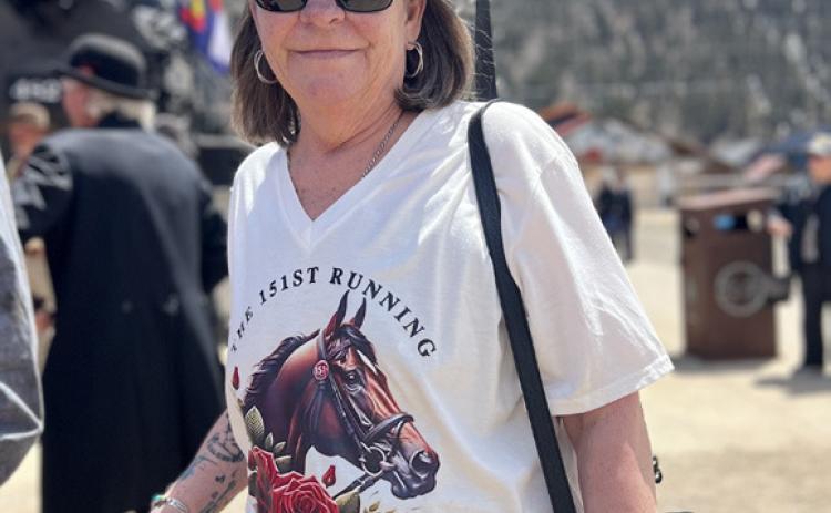 Handlebar Holly, who is now the owner of the Shady Lady Saloon, was wearing her Kentucky Derby best while greeting the train. Photo credit DeAnne Gallegos