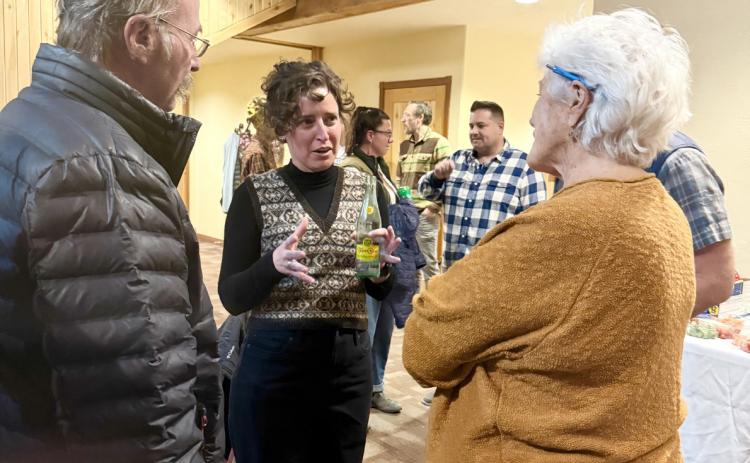 Elizabeth Stuffings talks with San Juan County Comissioner Scott Fetchenhier and community member Sue Morris