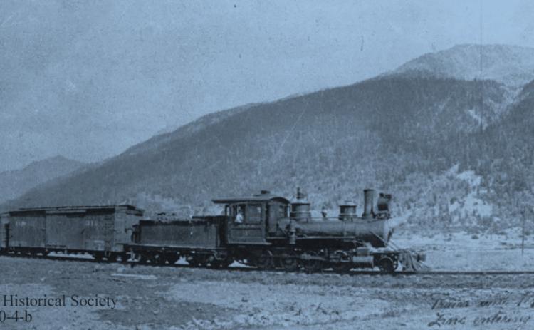 A Silverton Northern Railroad train hauls 10 carloads of zinc concentrates into Silverton, around 1925, pulled by SN #4, with two men on the third boxcar. San Juan County Historical Society photo