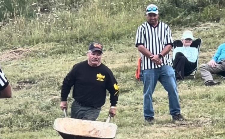 Terry Rhoades competing in the wheelbarrow race. Photo credit DeAnne Gallegos