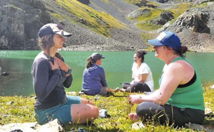 Women connecting at a glacier lake during the Silverton, CO New Moon Hike