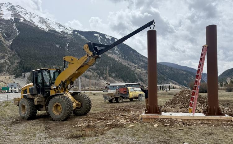 The Town of Silverton Public Works crew place and bolt down the new entryway sign poles on Monday photo by John Zarkis