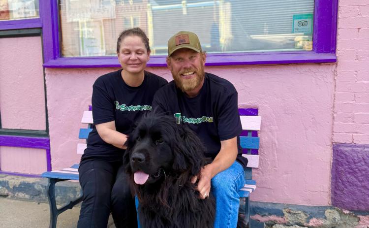 Sherrie &amp; Chris Martin sit out front of T’s Smokehouse after a busy day with their dog Nola. Photo by DeAnne Gallegos