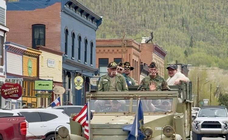 Local veterans ride the vintage halftrack down Greene St on Memorial Day photo by DeAnne Gallegos
