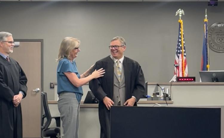 Jane Edwards adjusts her husband, San Juan County Judge Anthony Edwards, robe before his swearing in ceremony at the Archuleta County Courthouse in Pagosa Springs on November 13th, 2025, Judge Reid Stewart is on the far left. Photo by Jane Edwards