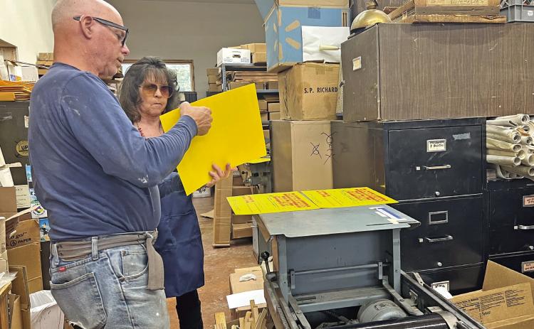 Judy Kuhlman and Tom Lanis work on the printing of the Hardrockers Holiday 50th Anniversary posters Photo credit DeAnne Gallegos